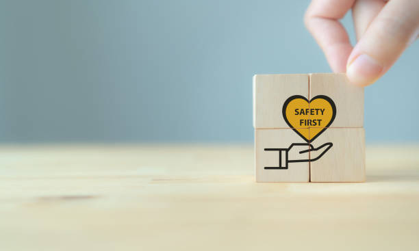 istock Safety first symbols, work safety, caution work hazards, danger surveillance, zero accident concept. Wooden cubes with smart grey background. Employees safety awareness at workplace. Safety banner. 1393153664