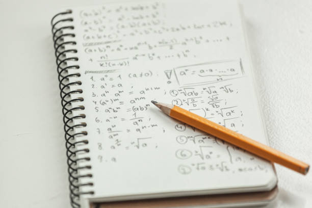 istock Math formulas are written in pencil on a piece of paper, math problems 1393153668