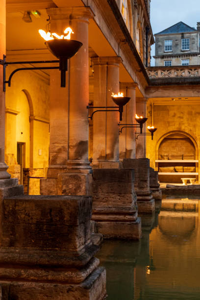 Restored ancient Roman Baths in the evening in Bath town. stock photo