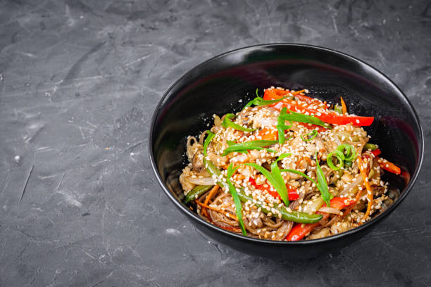 istock delicious chinese fried noodles on a black background 1393155020