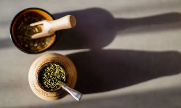 Healthy infused drink, energy boosting beverage on neutral wooden table.