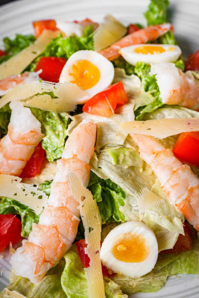 istock fresh salad with shrimp and parmesan on a black background 1393158682