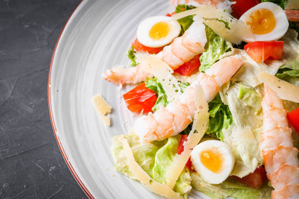 istock fresh salad with shrimp and parmesan on a black background 1393158684