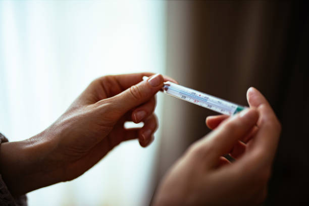 istock Unrecognizable Woman Holding Thermometer 1393158789