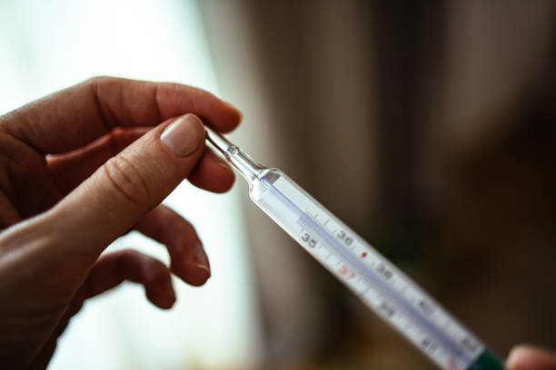 istock Unrecognizable Woman Holding Thermometer 1393158800