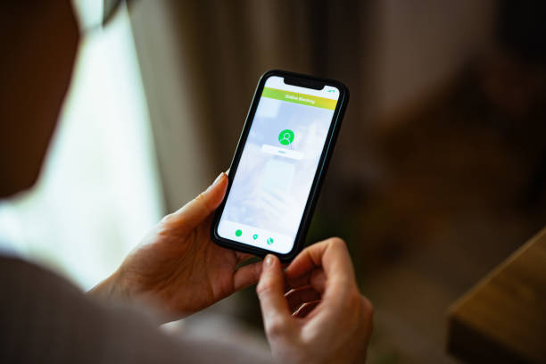 istock An Anonymous Woman Using A Mobile Phone App For Online Banking 1393158802