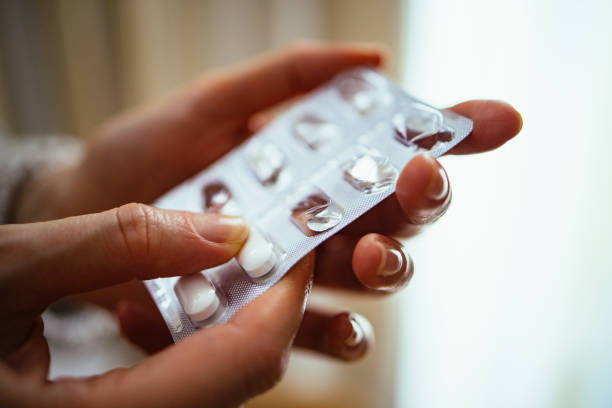 istock Unrecognizable Woman Taking Medicine At Home 1393158839