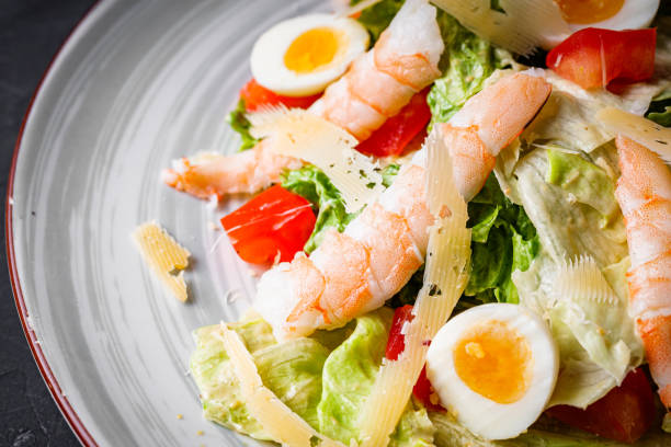 istock fresh salad with shrimp and parmesan on a black background 1393158947