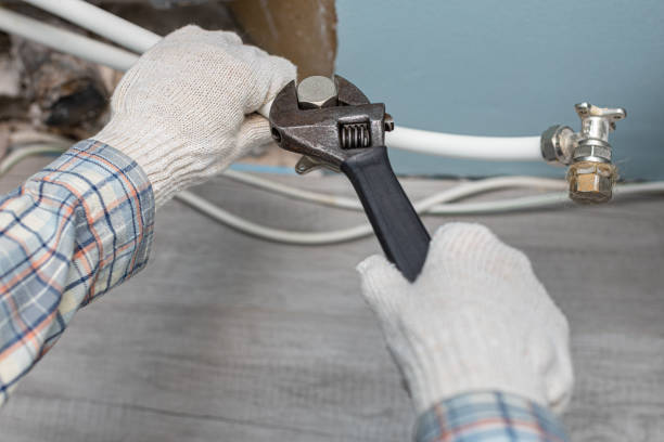 istock man unscrews the plug on the water supply pipe 1393161872
