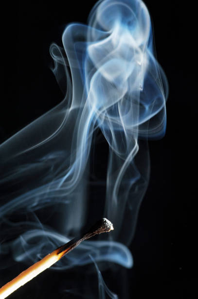istock Wooden match on a black background 1393163069