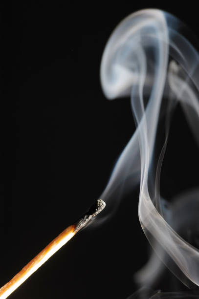 istock Wooden match on a black background 1393163080