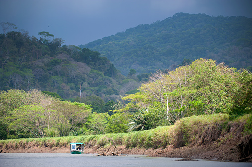 Impending tropical storm over tourboat on Tarcoles River, Costa Rica. Costa Rica is the central American country north of Panama that is renowned for its tropical birdlife, exotic wildlife and adventure pursuits such as whitewater rafting, parasailing and ziplining