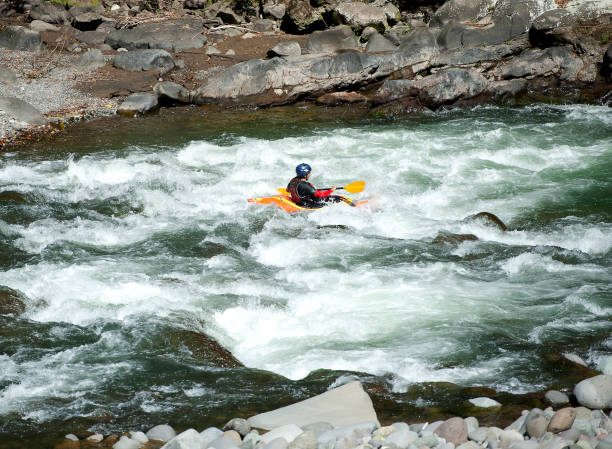 Single kayak in ravine on rough white water, Pacuare River, Costa Rica. Costa Rica is the central American country north of Panama that is renowned for its tropical birdlife, exotic wildlife and adventure pursuits such as whitewater rafting, parasailing and ziplining