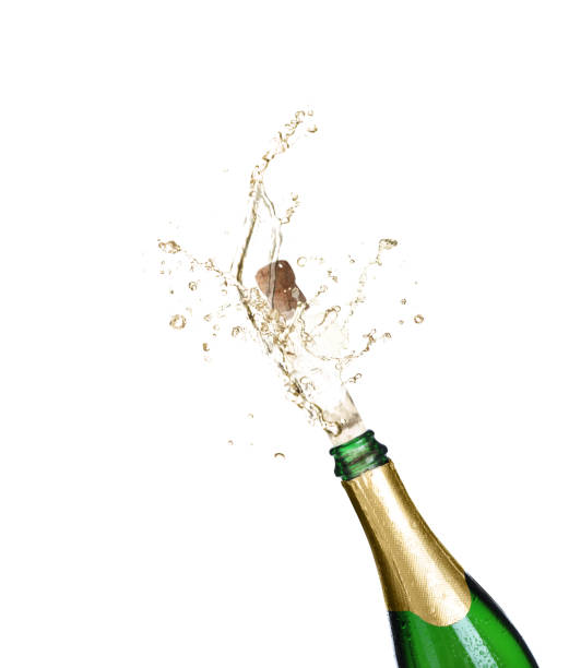 istock Sparkling wine splashing out of bottle on white background 1393164841