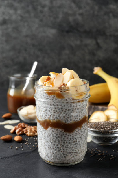 istock Delicious chia pudding with banana, walnuts and caramel sauce on black table 1393165729