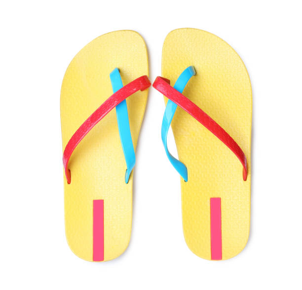 istock Pair of yellow flip flops isolated on white, top view 1393165888