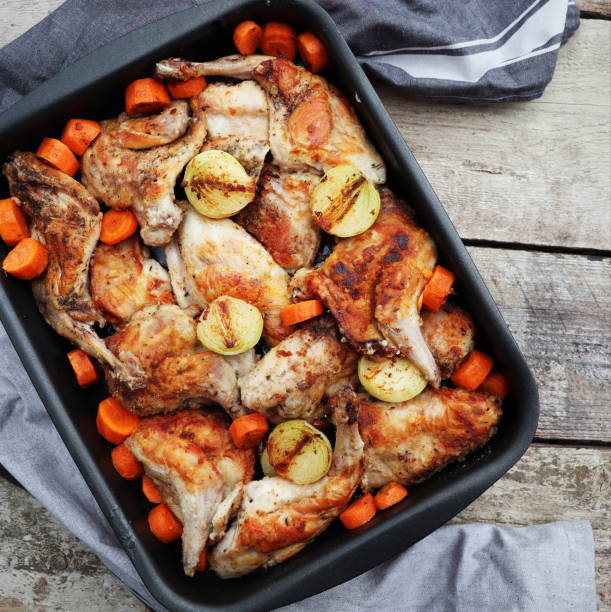 istock Roasted Hare Haunches in Pan with Stewed Vegetables on Rustic Wooden Table Surface 1393166050