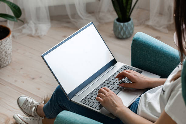 istock Young woman using laptop screen mockup to work home, remote work 1393166106