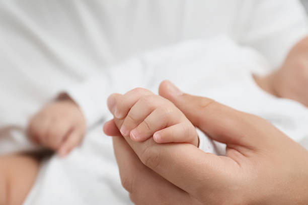 istock Father holding his cute baby, closeup view 1393167385