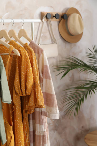 istock Different stylish clothes hanging on rack in room 1393168718