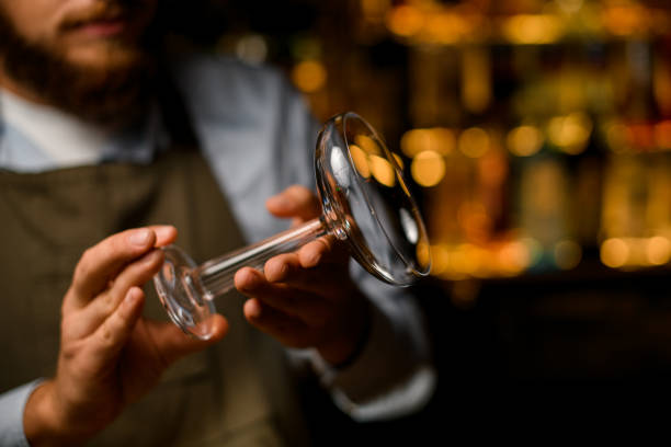 istock selective focus on beautiful transparent wine glass in male hands 1393169011