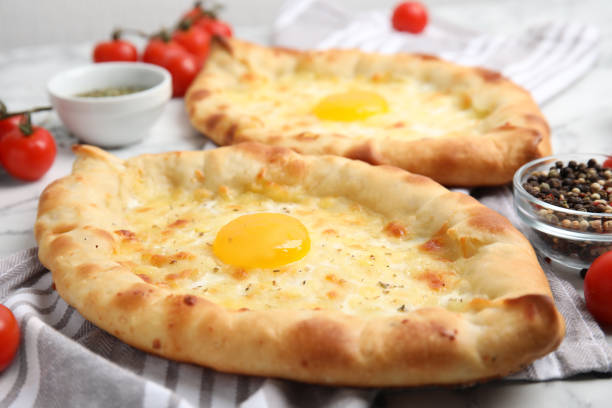 istock Fresh delicious Adjarian khachapuris on table, closeup 1393170496