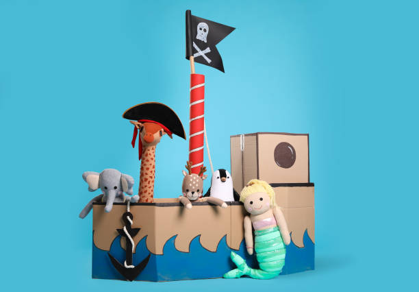 istock Pirate cardboard ship and toys on turquoise background 1393170692