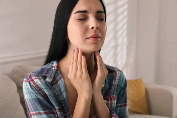 istock Young woman doing thyroid self examination at home 1393170843
