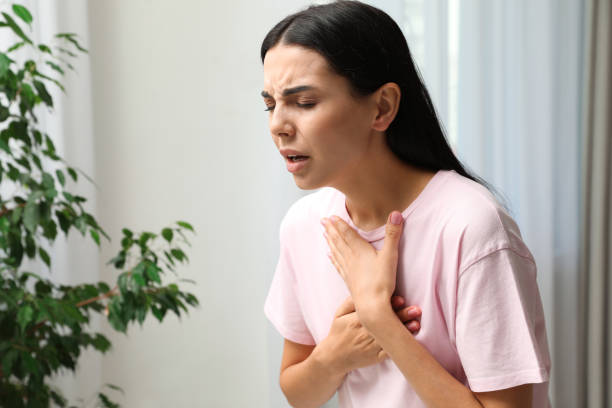 istock Young woman suffering from breathing problem indoors 1393171381