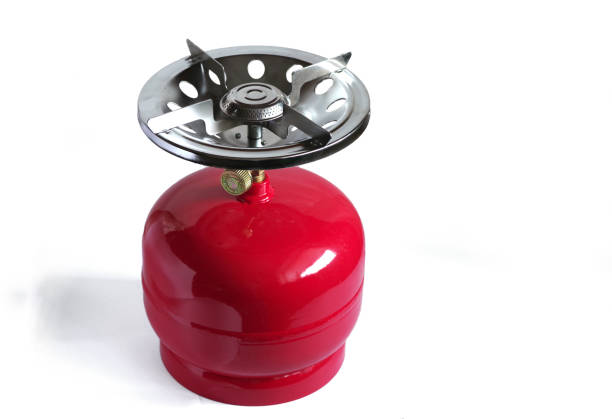 Compact metal gas cylinder and burner for a camping stove. Isolated on white background.
