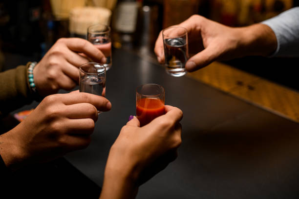 male hands cheer with glasses of vodka and liqueur - men elegance cocktail cool imagens e fotografias de stock