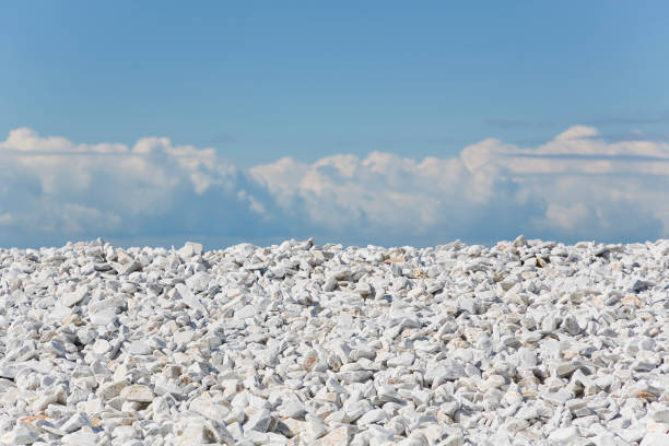 White and gray stones softly rounded against a blue sky