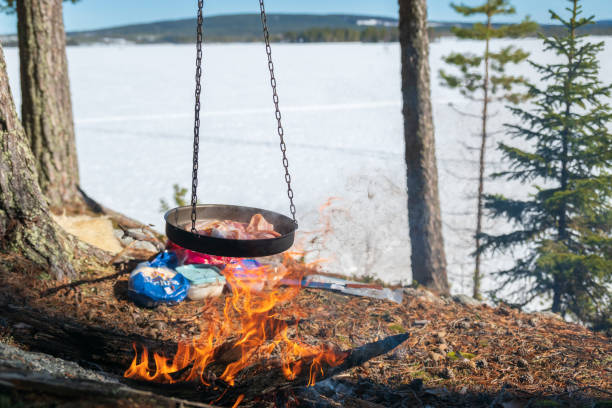 istock Bacon in a frying pan over a camp fire. 1393177956