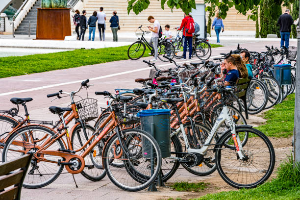 Valencia-Spain. 22 April 2022. Several touristic rental bikes parked in city a park. Valencia is known as mobility city and has many kilometers of bicycle lanes.