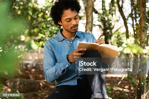 istock man writing in notebook ideas and enjoying nature 1393183265