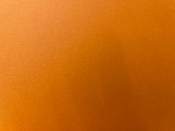 istock Close up of textured orange paper background 1393186618