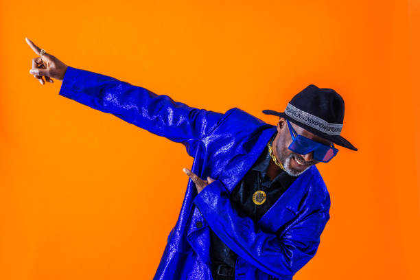 Cool senior man with fashionable outfit portrait Cool senior man with fashionable clothing style portrait on colored background - Funny old male pensioner with eccentric style having fun dab dance stock pictures, royalty-free photos & images