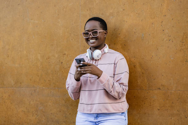 istock Young woman using smart phone and smiling 1393189232
