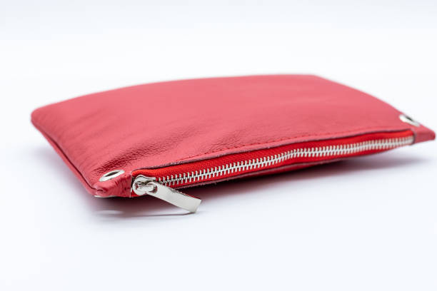 istock Modern closed cosmetic bag ,red color, with zipper isolated on white background. side view.luxury cosmetic travel bag with round belt holes.clutch bags. Copy space 1393190143