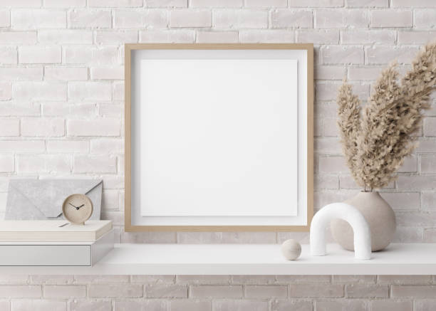 istock Empty square picture frame on white brick wall in modern room. Mock up interior in contemporary style. Free, copy space for picture. Pampas grass in vase, books, sculpture. 3D rendering. 1393191306