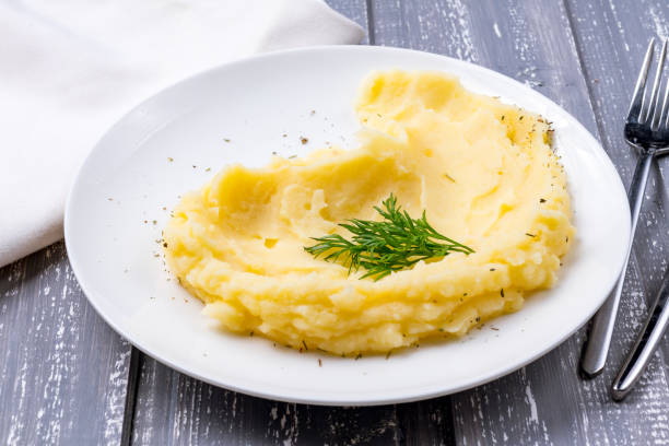 istock mashed potatoes on a white plate on grey wooden table 1393197658
