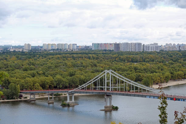 Kyiv, Ukraine overlook of city and river bridge in Kiev summer with view of residential neighborhood Darnytsia suburbs Soviet and modern buildings stock photo