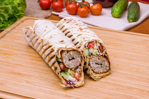 istock roll with beef lula kebab with vegetables on the Board 1393198066