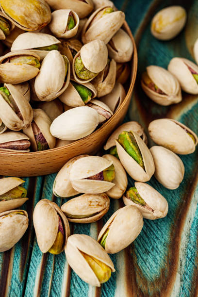 istock fresh salted pistachios on a wooden rustic background 1393198183