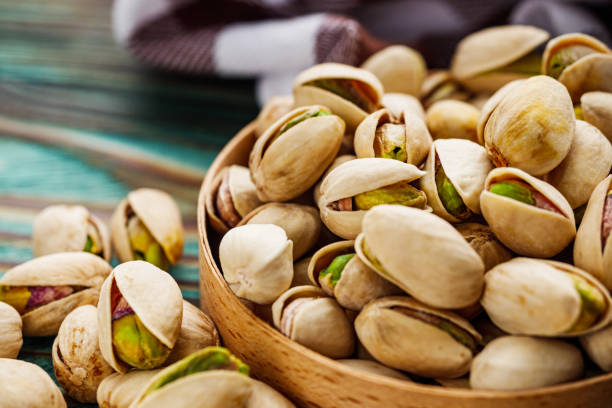 istock fresh salted pistachios on a wooden rustic background 1393198195