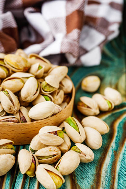 istock fresh salted pistachios on a wooden rustic background 1393198206