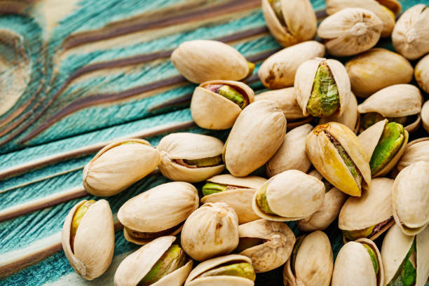 istock fresh salted pistachios on a wooden rustic background 1393198750