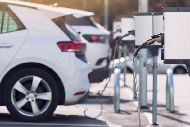 charging stations for electric cars at a parking lot - electric car imagens e fotografias de stock