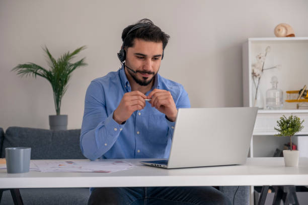 istock handsome young businessman talking online with computer at home 1393201732