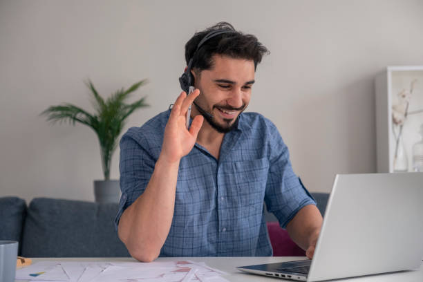 istock young businessman talking online says hello 1393201736